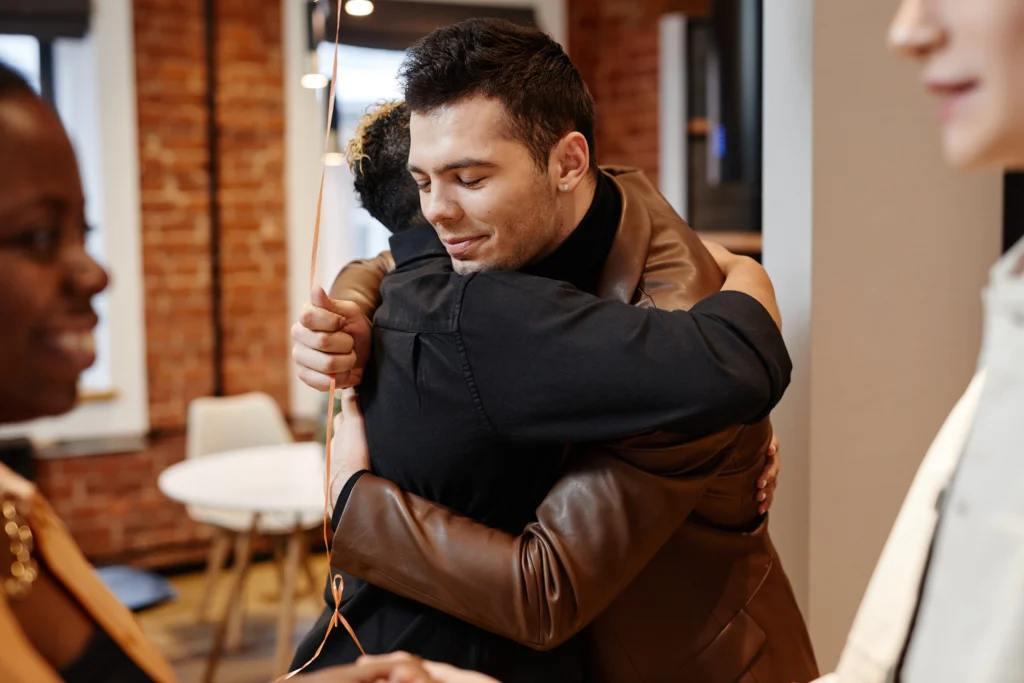A Working Wardrobes client greeting a staff member with a warm hug